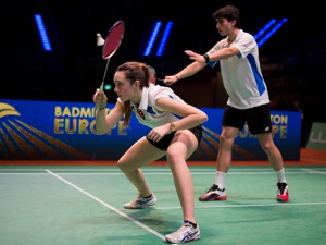 Man and woman playing badminton